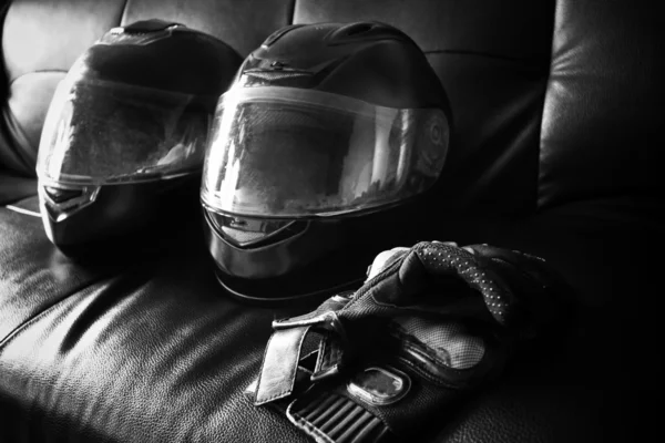 Helmet and leather gloves on sofa — Stock Photo, Image