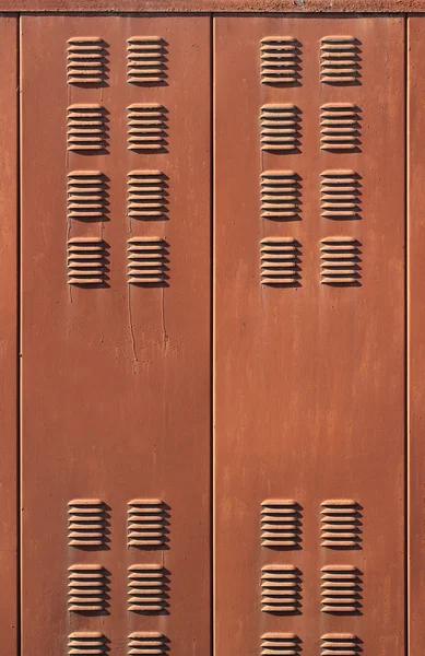 Background with rusty brown metal ventilation grille doors Royalty Free Stock Images