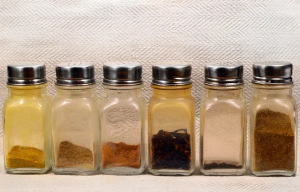 Glass shakers with spices and condiments. — Stock Photo, Image