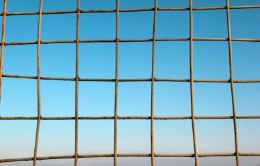 Mavi gökyüzü arka plan üzerinde Kablolu çit