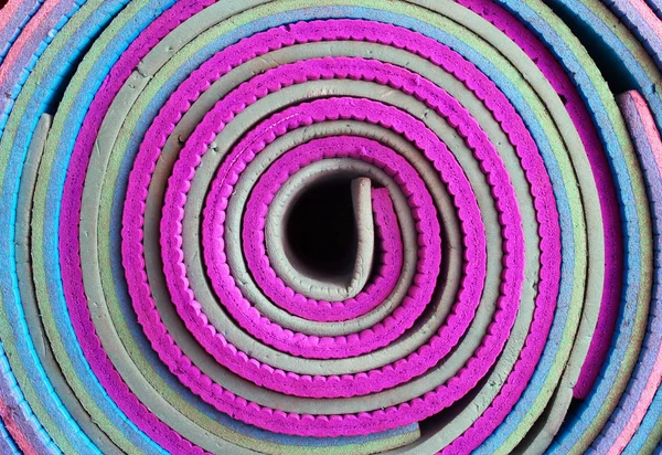 Colorful sleeping mats rolled in a bobbin