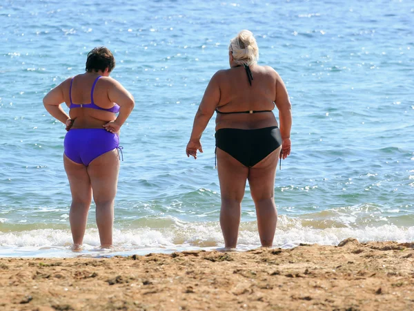 Two adult plus size women on a beach. — Stock Photo, Image