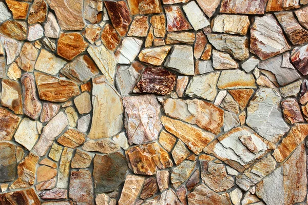 Yellow brown stone granite boulder wall mosaic texture background — Stock Photo, Image