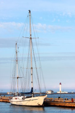 arka planda deniz feneri ile Marinada yat