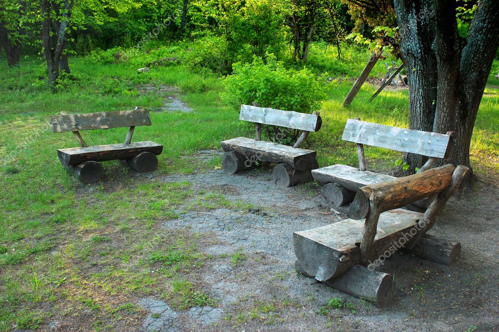 Old Wooden Benches Hand Made From Tree Trunks In The Forest