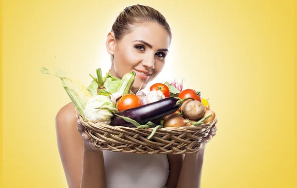 Young woman holding vegetable — Stock Photo, Image