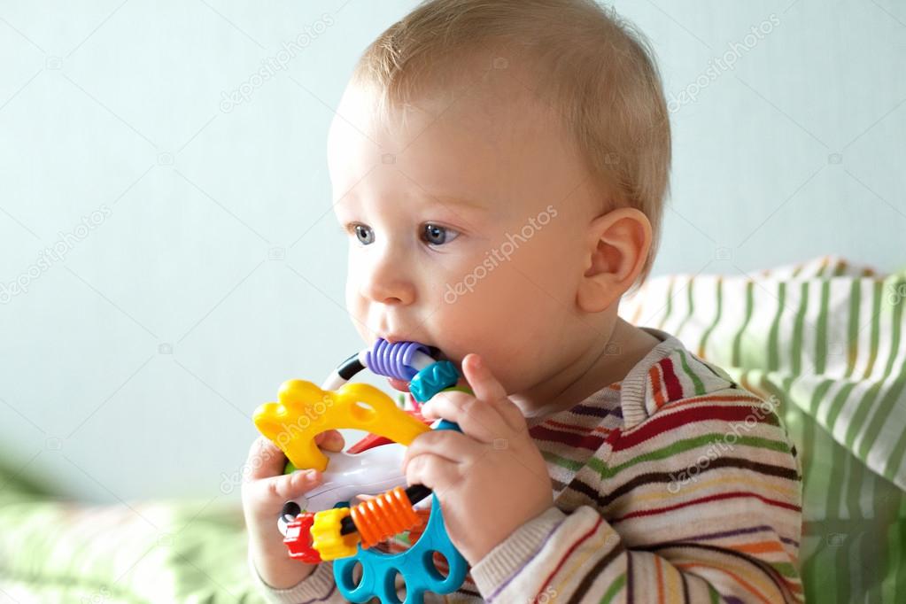 Baby playing with  toy ball shape