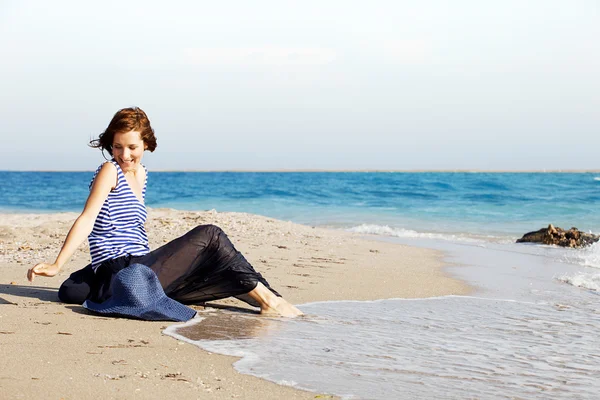 Hermosa mujer bronceada descansando en la playa en el día de verano Imagen de archivo
