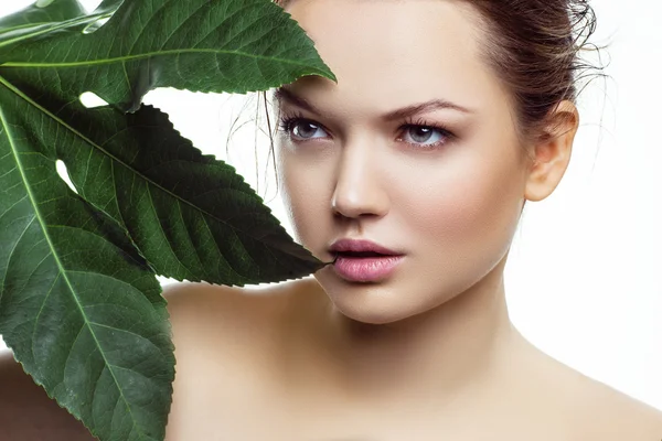 Woman with palm leaf. Stock Photo