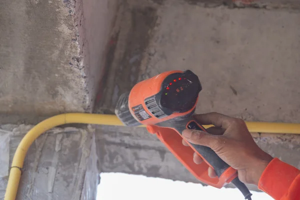 Hand use a heat gun to bending electric PVC pipe — Stock Photo, Image