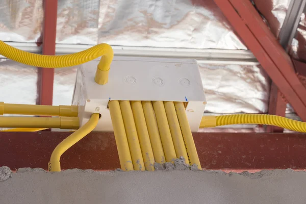 Yellow PVC pipes for electrical boxes and wires buried on concre — Stock Photo, Image