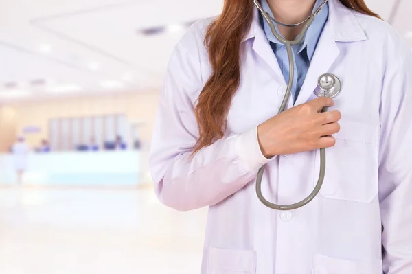Женщина-врач слушает его сердце стетоскопом в больнице — стоковое фото