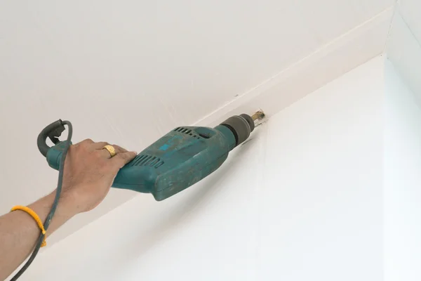 Drilling a ceiling with electric drill — Stock Photo, Image