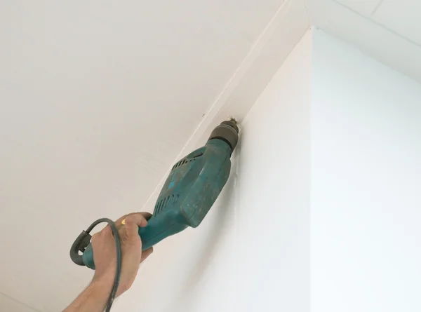 Drilling a ceiling with electric drill — Stock Photo, Image