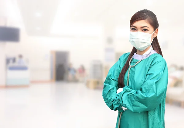 Female doctor wearing a green scrubs and stethoscope in hospital — Stock Photo, Image