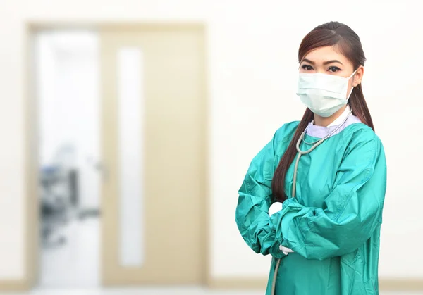 Female doctor wearing a green scrubs and stethoscope in hospital — Stock Photo, Image