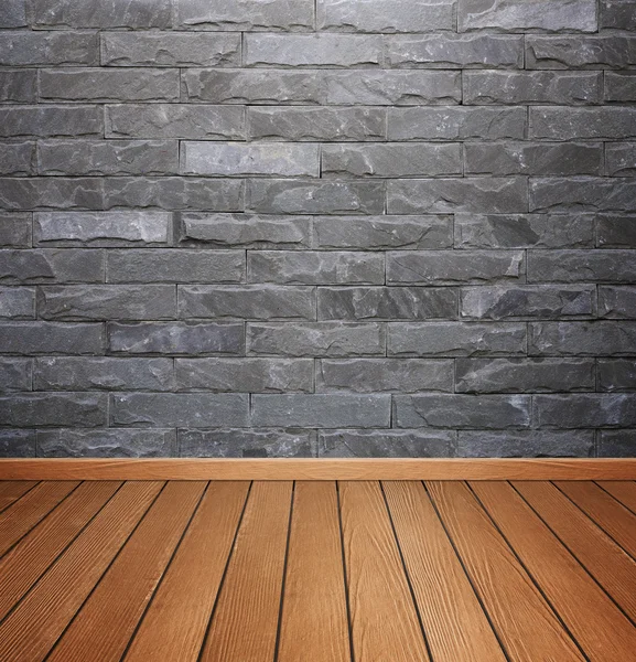 Interior de la habitación con baldosas de piedra de ladrillo pared y piso de madera backgro —  Fotos de Stock