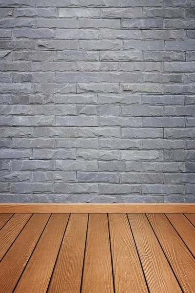 Interior de la habitación con baldosas de piedra de ladrillo pared y piso de madera backgro —  Fotos de Stock