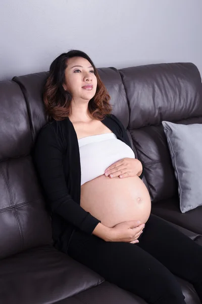 Mulher grávida descansando em casa no sofá — Fotografia de Stock