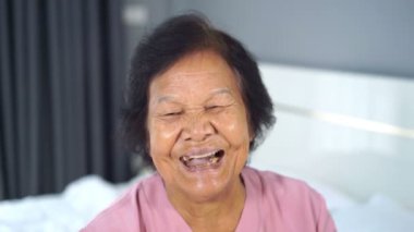 Gülümseyen yaşlı kadının yavaş çekimi.