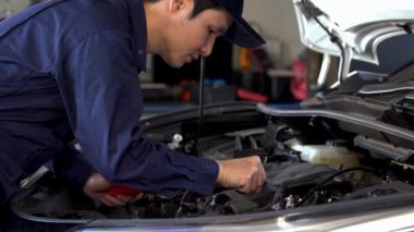 Erkek tamirci araba motoru sorununu kontrol ediyor