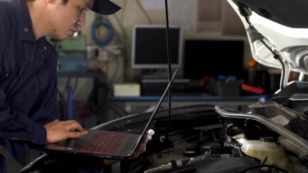 Mecánico Masculino Usando Ordenador Portátil Mientras Repara Coche Servicio Automático — Vídeo de stock