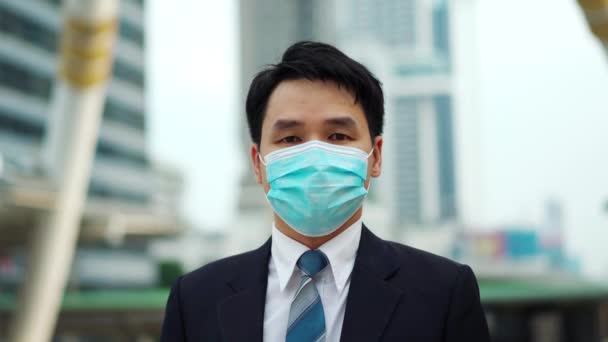 市内のコロナウイルス Covid パンデミックの際の医療マスクを持つビジネスマン — ストック動画