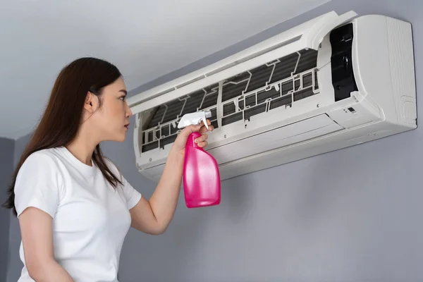 Young Woman Cleaning Air Conditioner Indoors Home — Stock Photo, Image