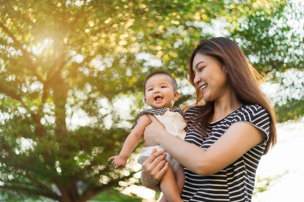 Happy Mother Holding Newborn Baby Tender Embrace Green Nature Bokeh — Stock Photo, Image