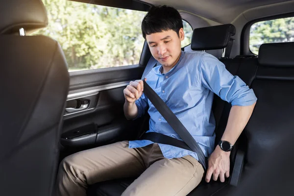 Joven Sujetando Cinturón Seguridad Mientras Está Sentado Asiento Trasero Del — Foto de Stock