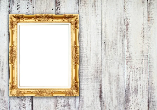 Moldura dourada em branco na parede de madeira — Fotografia de Stock