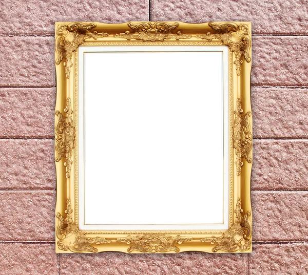 Moldura dourada em branco na parede de pedra de tijolo — Fotografia de Stock