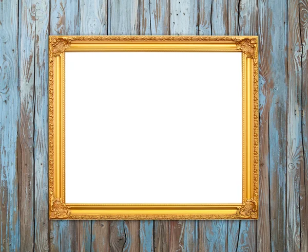 Blank golden frame on wood wall — Stock Photo, Image