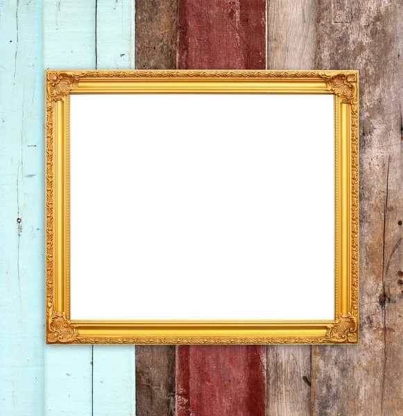 Blank golden frame on wood wall — Stock Photo, Image