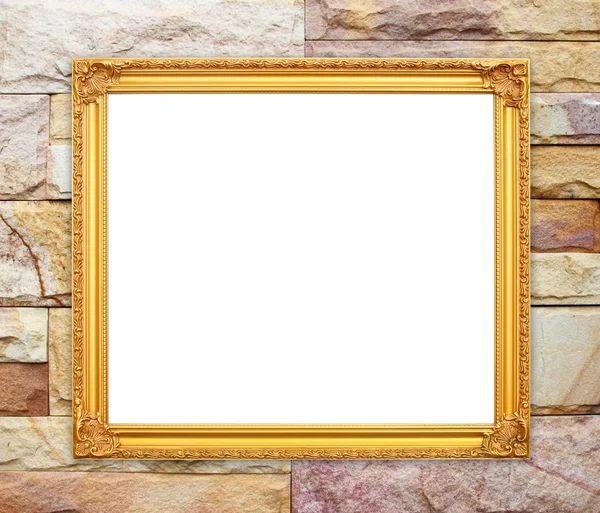 Moldura dourada em branco na parede de pedra de tijolo — Fotografia de Stock