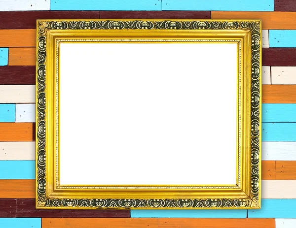 Blank golden frame on colorful wood wall — Stock Photo, Image