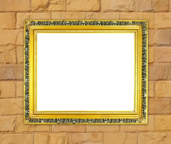Cadre doré vierge sur mur de pierre de brique — Photo