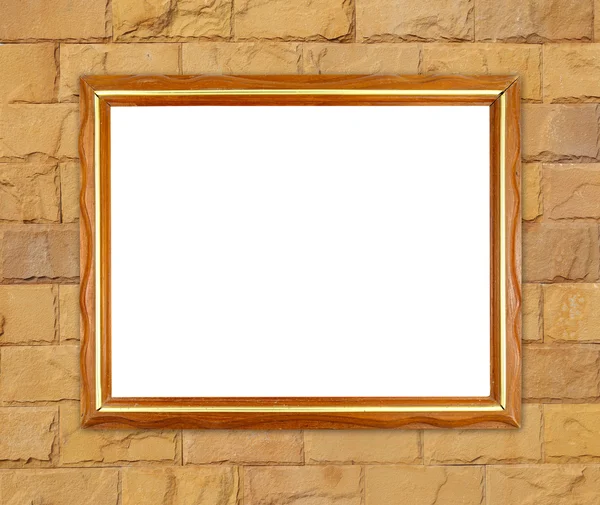 Moldura de madeira em branco na parede de pedra de tijolo — Fotografia de Stock