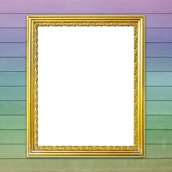 Золотая рамка на фоне разноцветной деревянной стены — стоковое фото