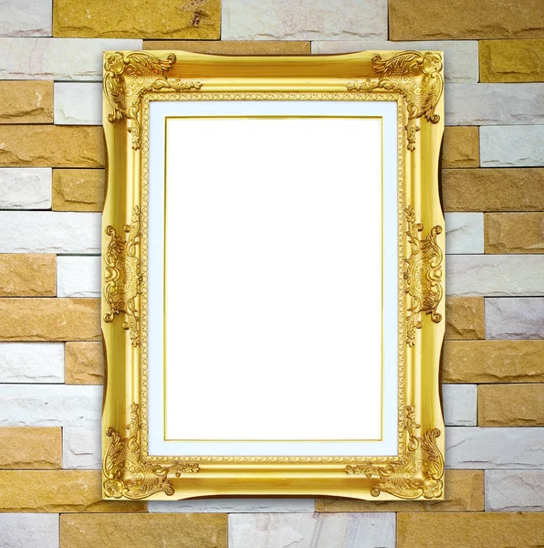 Gouden frame op baksteen stenen muur achtergrond — Stockfoto