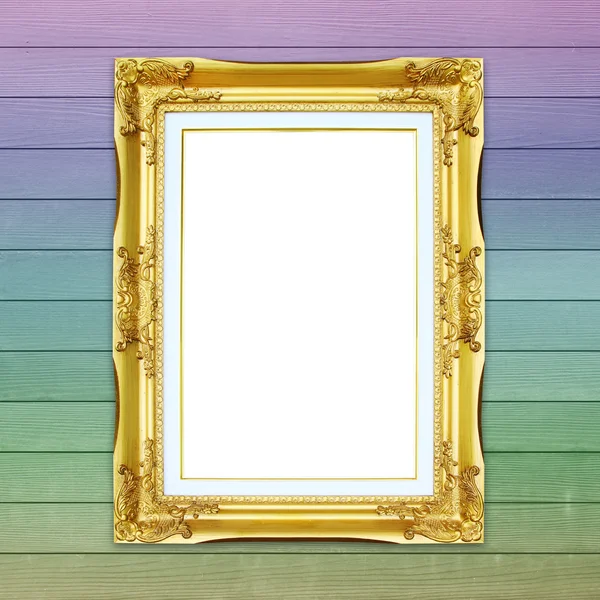 Golden frame on colorful wood wall background — Stock Photo, Image