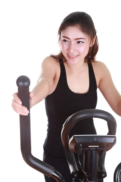 Young woman doing exercises with exercise machine — Stock Photo, Image