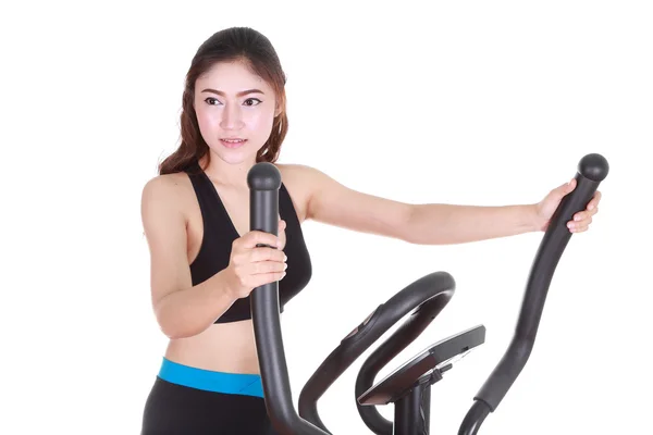 Young woman doing exercises with exercise machine — Stock Photo, Image