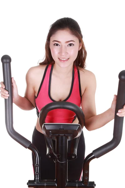 Young woman doing exercises with exercise machine — Stock Photo, Image