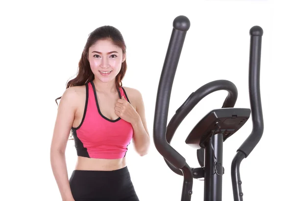 Young woman doing exercises with exercise machine — Stock Photo, Image