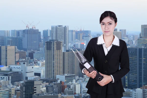 Business woman holding folder documents with city — Stock Photo, Image