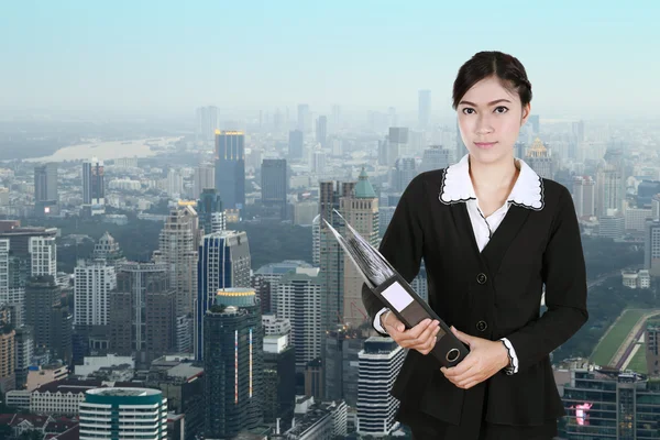 Business woman holding folder documents with city — Stock Photo, Image