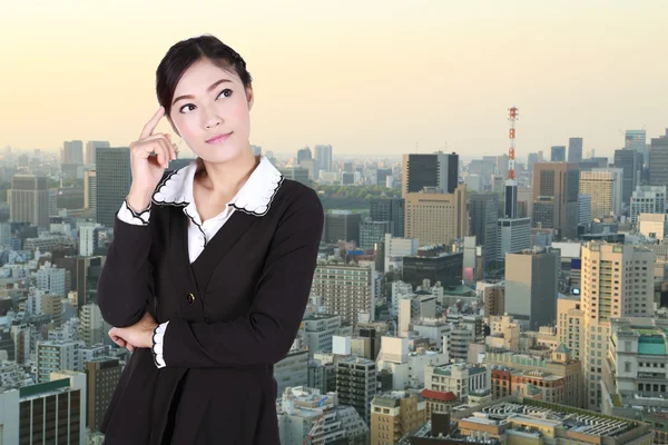 Business woman thinking with city — Stock Photo, Image