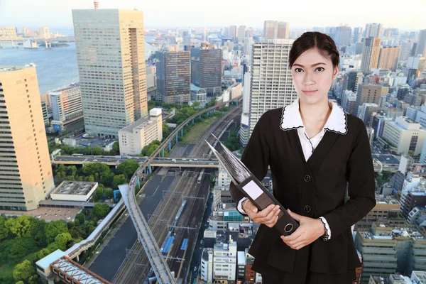 Business woman holding folder documents with city — Stock Photo, Image