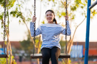 Parkta salıncakta sallanan kadın